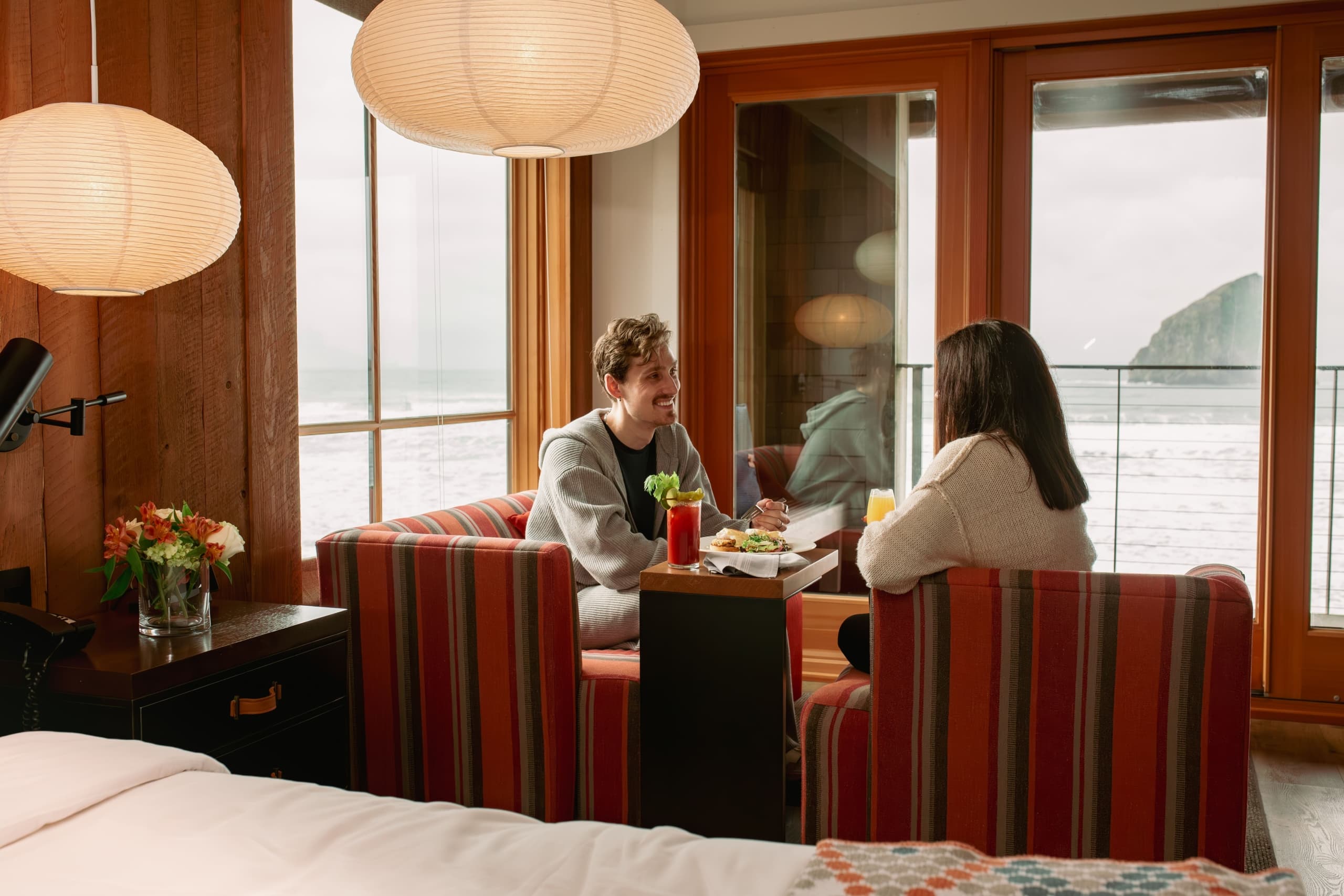A couple enjoying an in-room meal from Meridian Restaurant