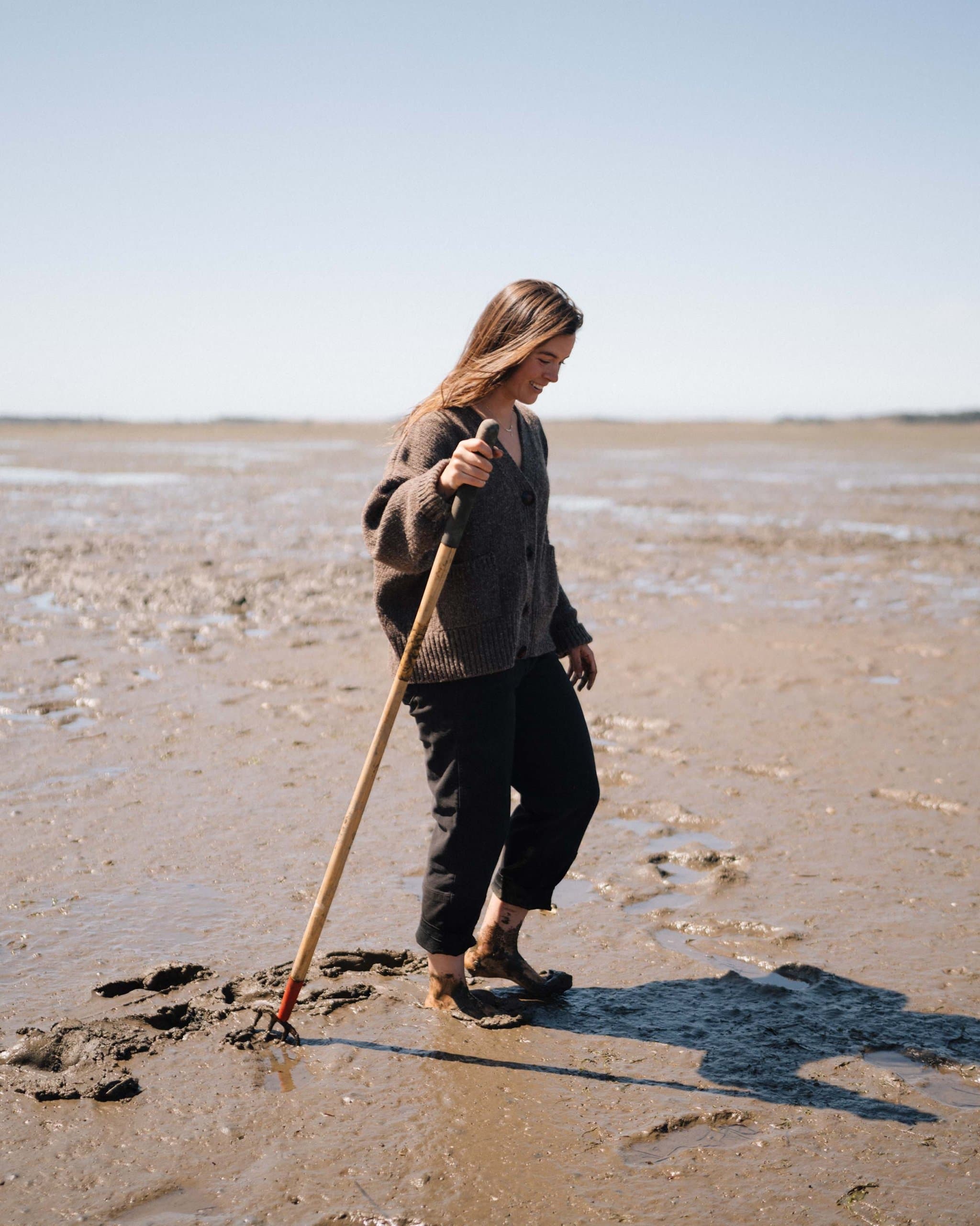 A woman clamming on the beach