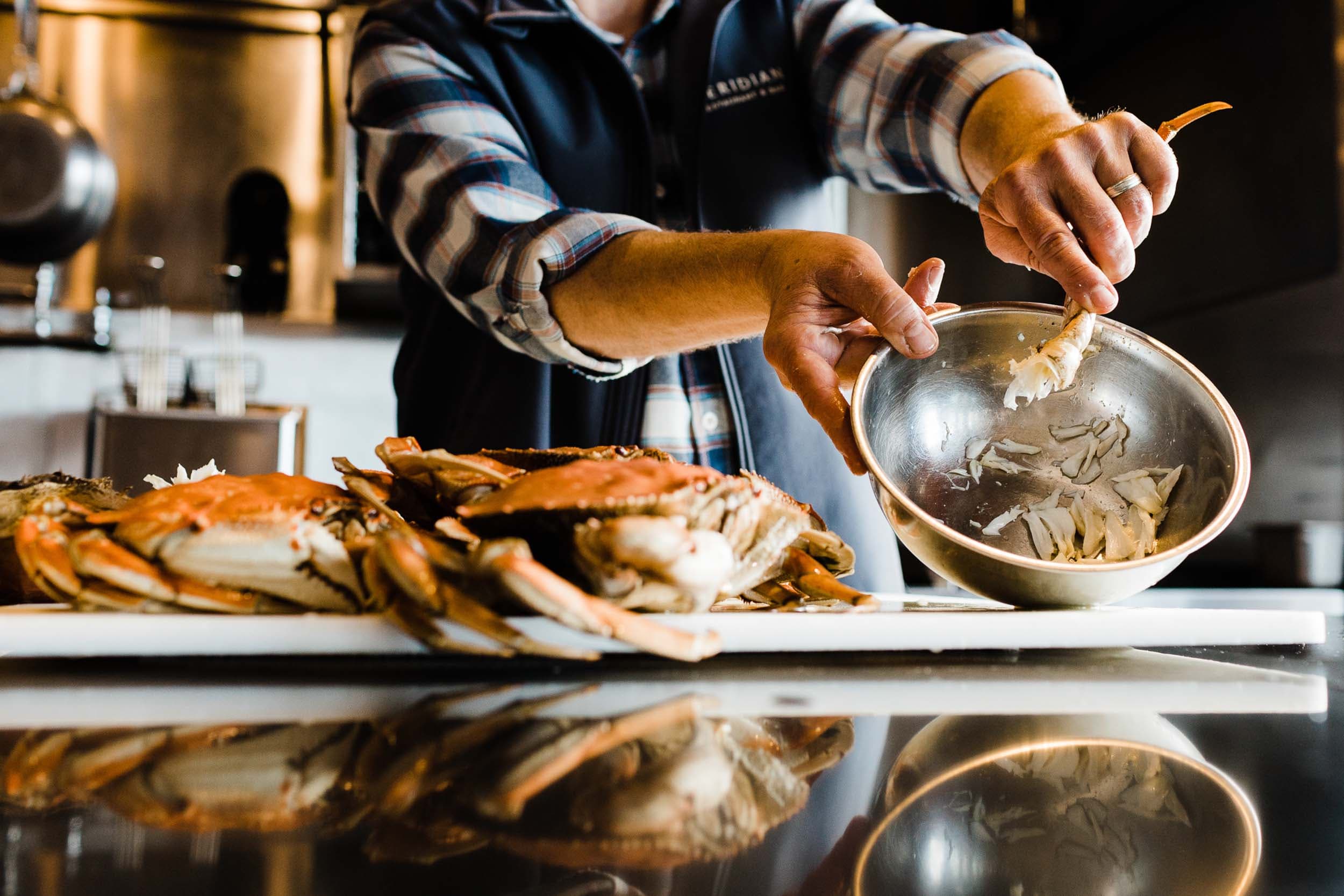 A chef showing crab meat he has picked in a mixing bowl at Meridian restaurant