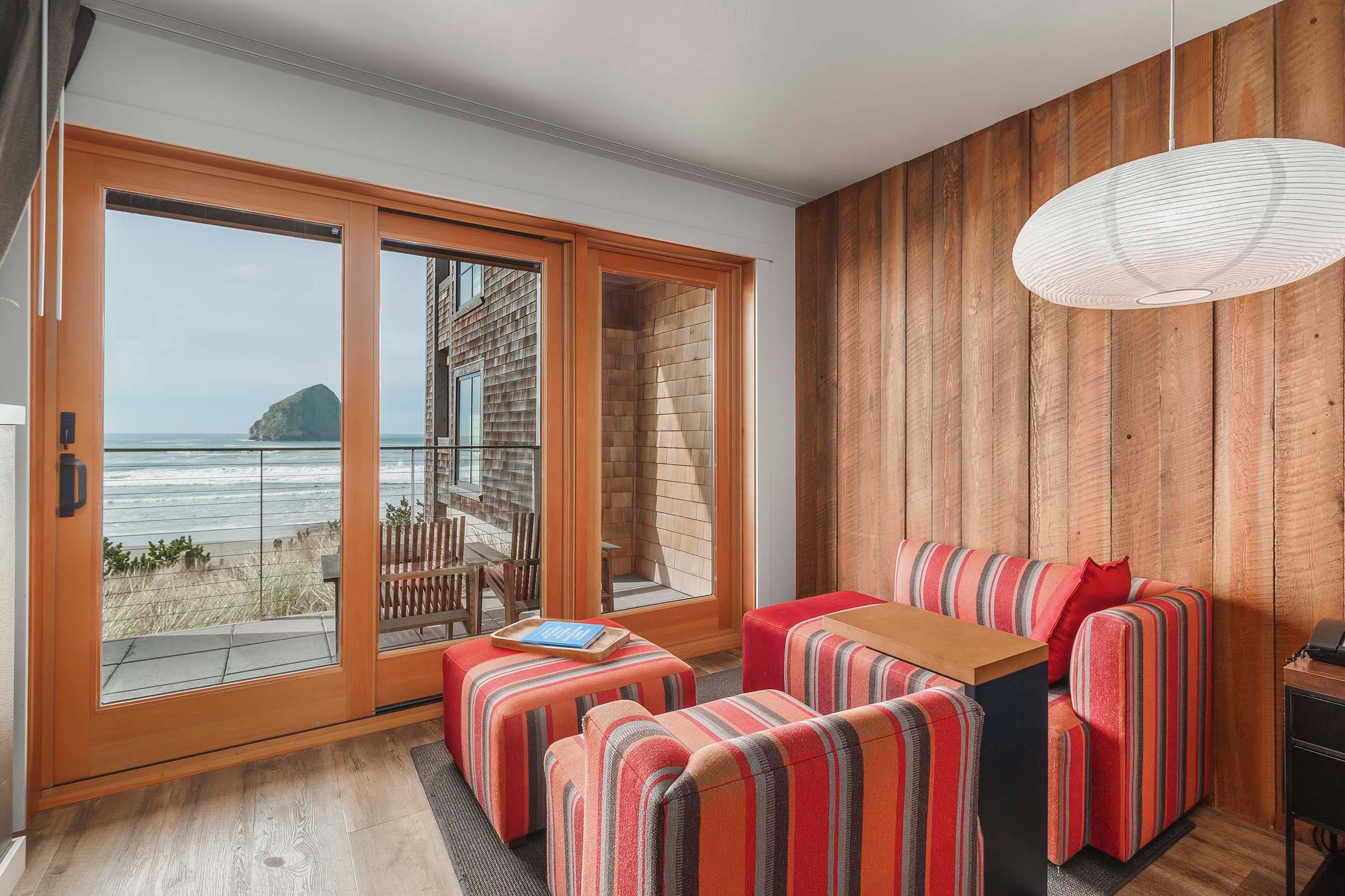 The lounge area in a King Signature room in the Oceanfront lodge at Headlands with a view of Haystack rock
