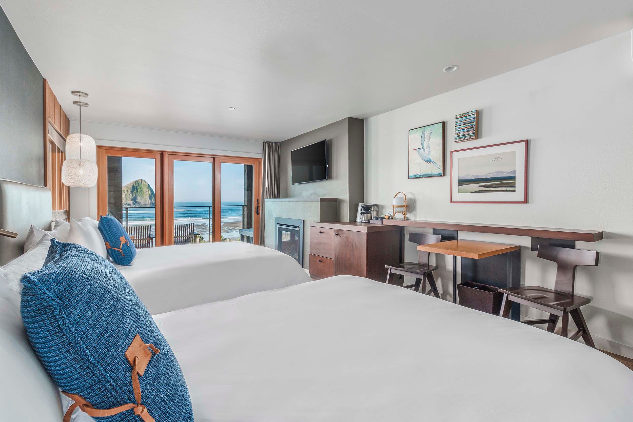 A room with a view of the ocean and Haystack rock from a Two Queens Sunlight lodge at Headlands