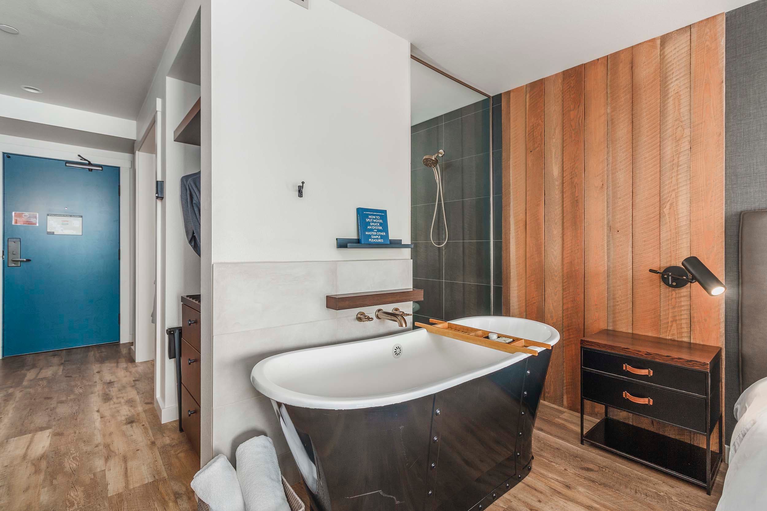 A soaker tub beside the bed in a King Sunlight room in the Oceanfront lodge at Headlands