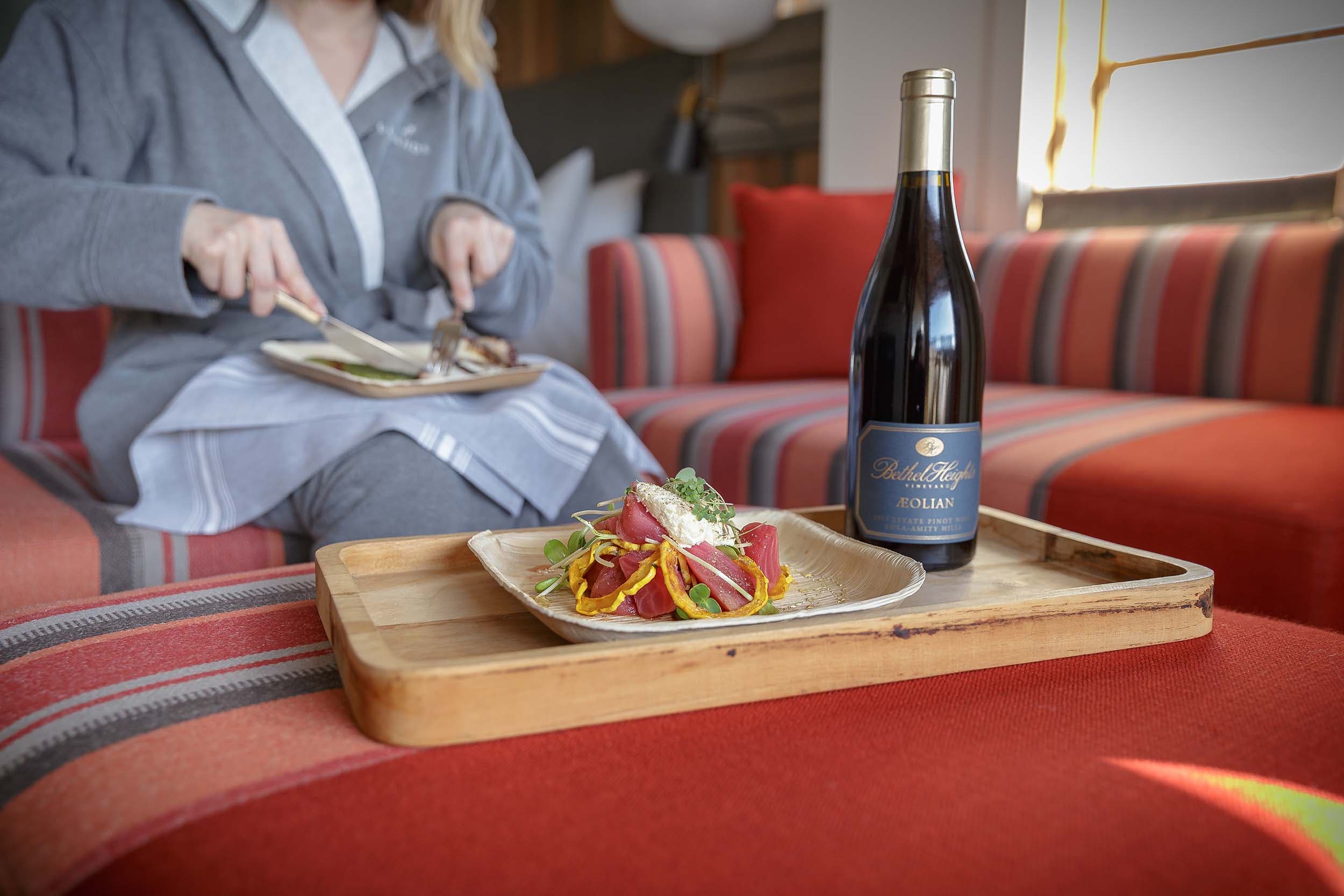 A woman eating some in-rooming dining dishes at Headlands