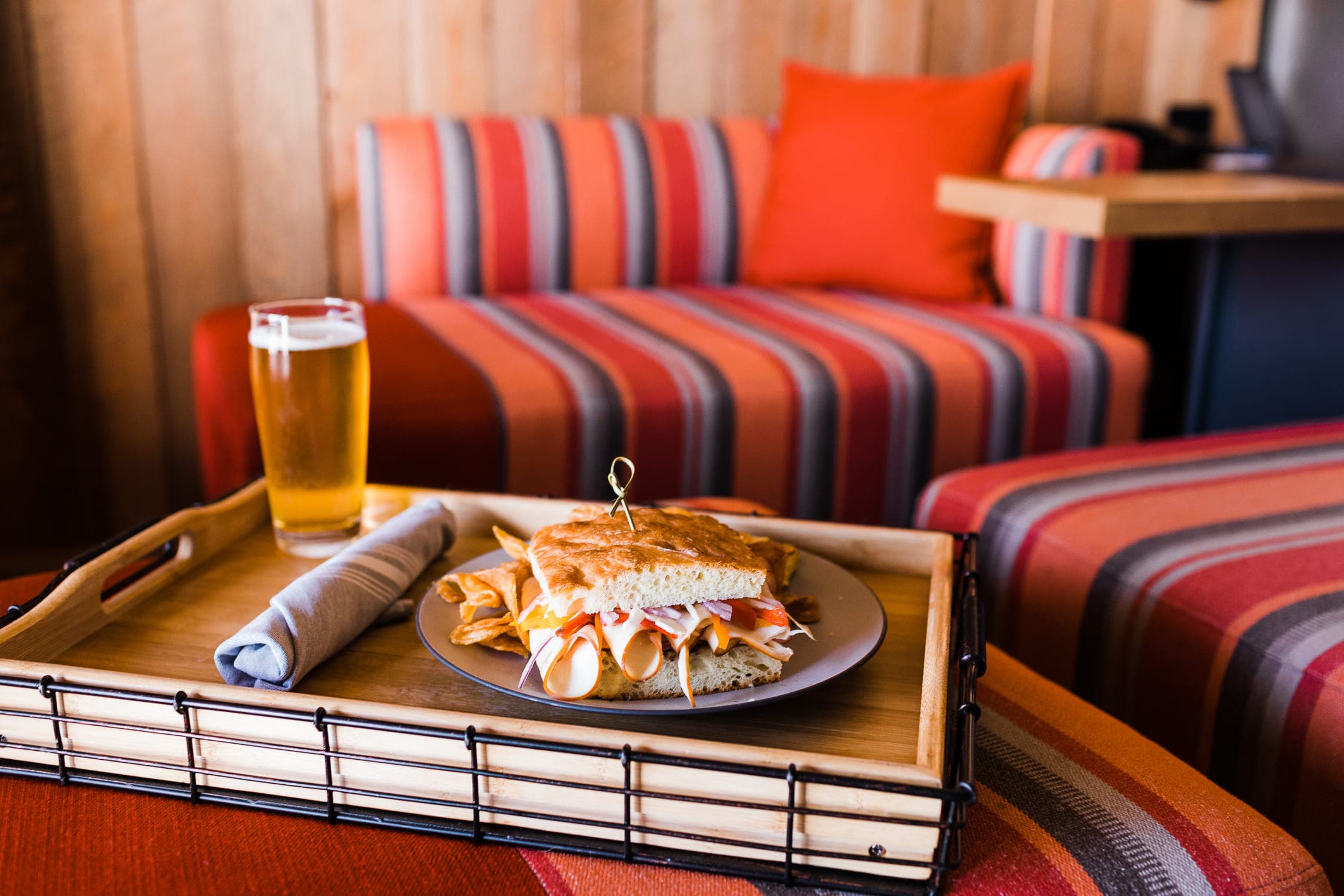 A sandwich and a beer in a room from Meridian Restaurant
