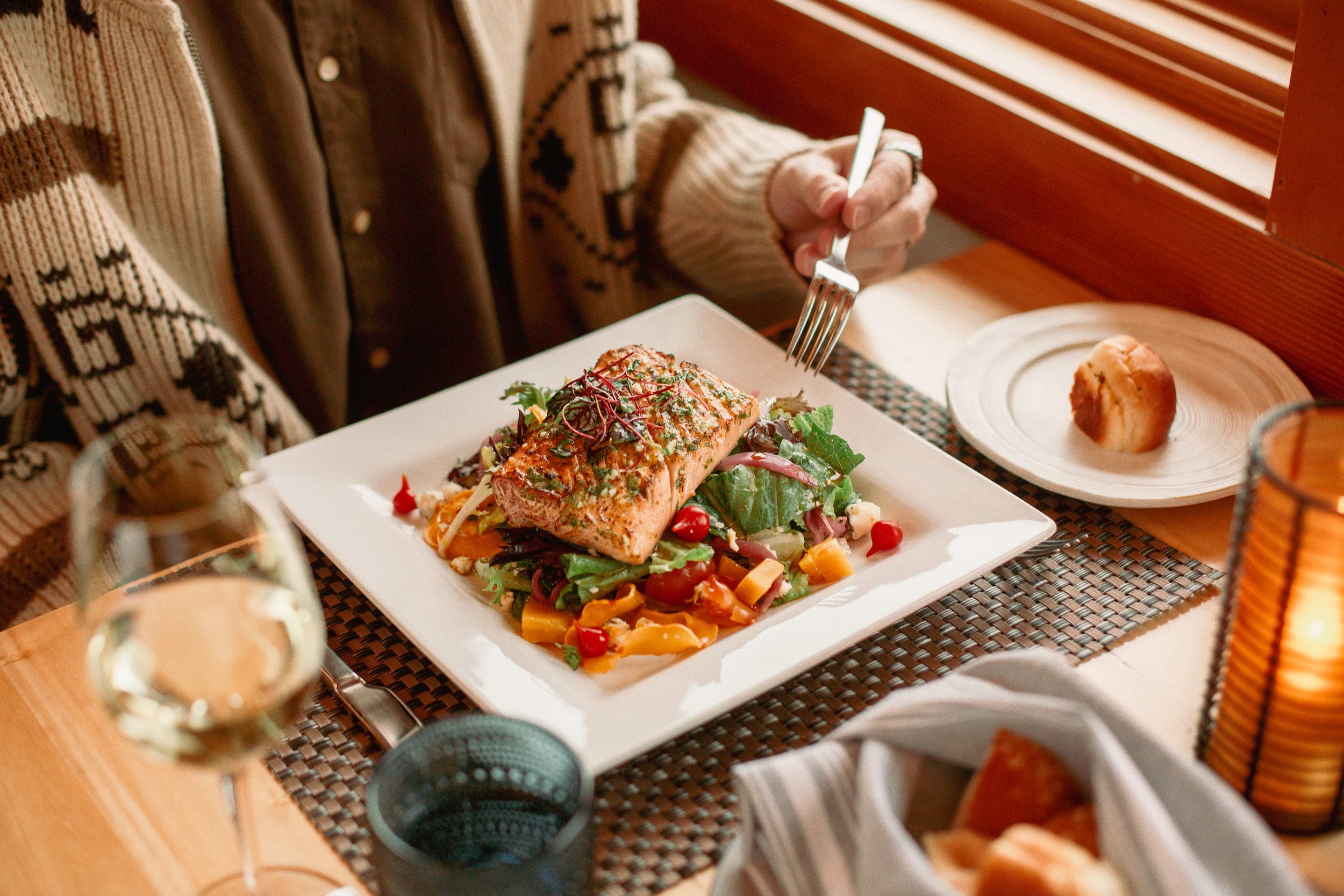 A plate of Salmon on top of a salad at Meridian Restaurant & Bar