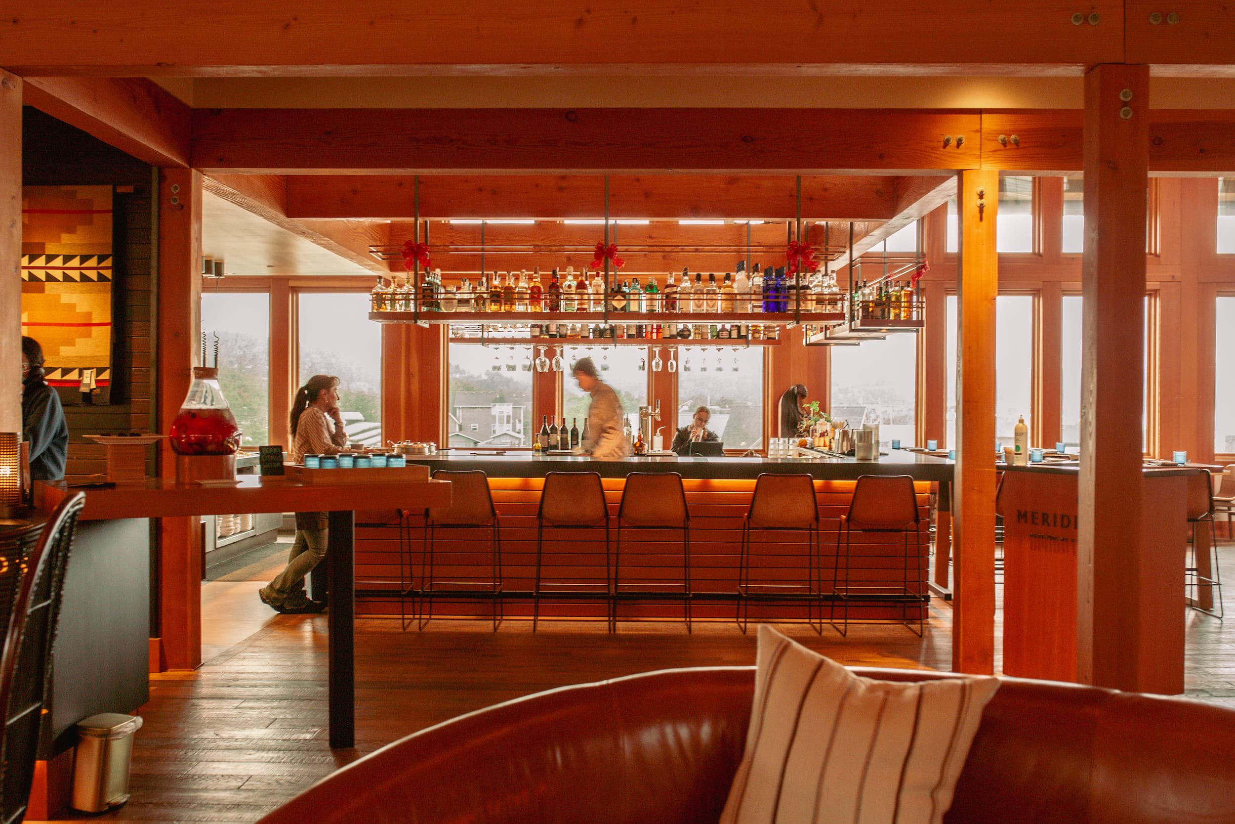 The bar area of Meridian Restaurant & Bar with a few customers and the bartender