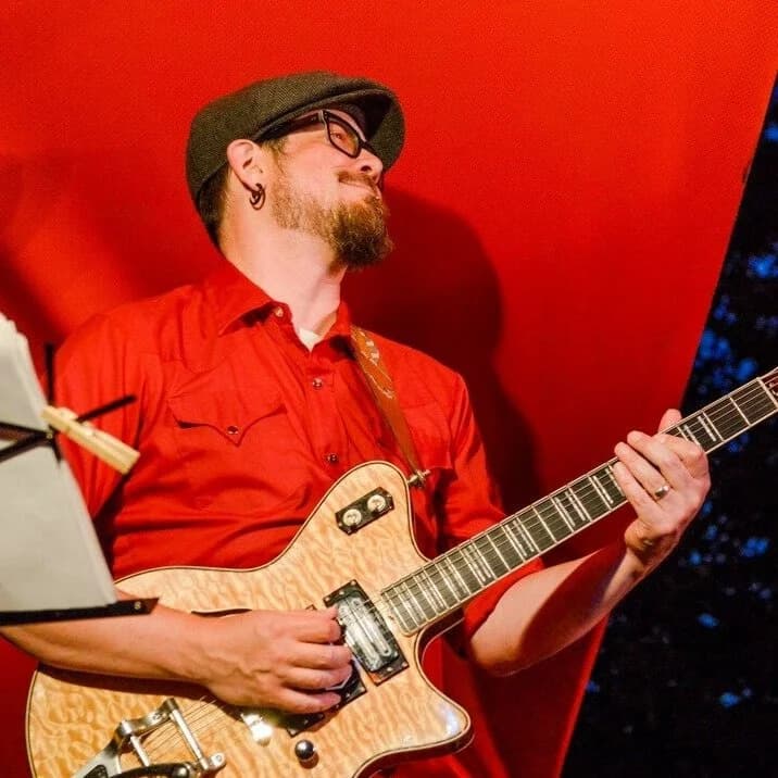 AG Donnaloia playing guitar on stage