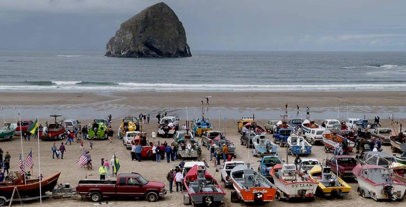 People with boats on a beach